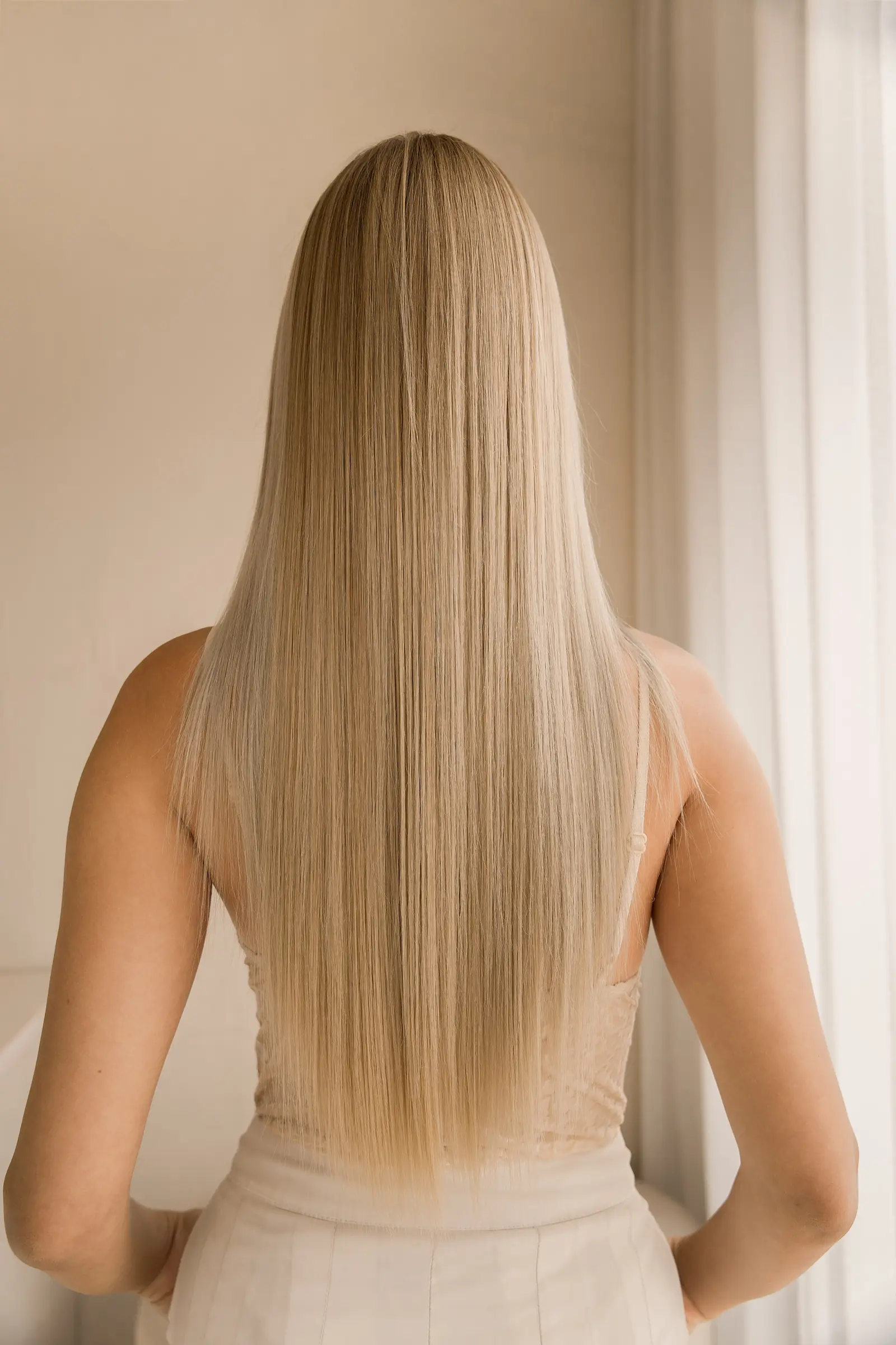 Smooth, glossy blonde hair after a Mermaid Gloss Keratin treatment